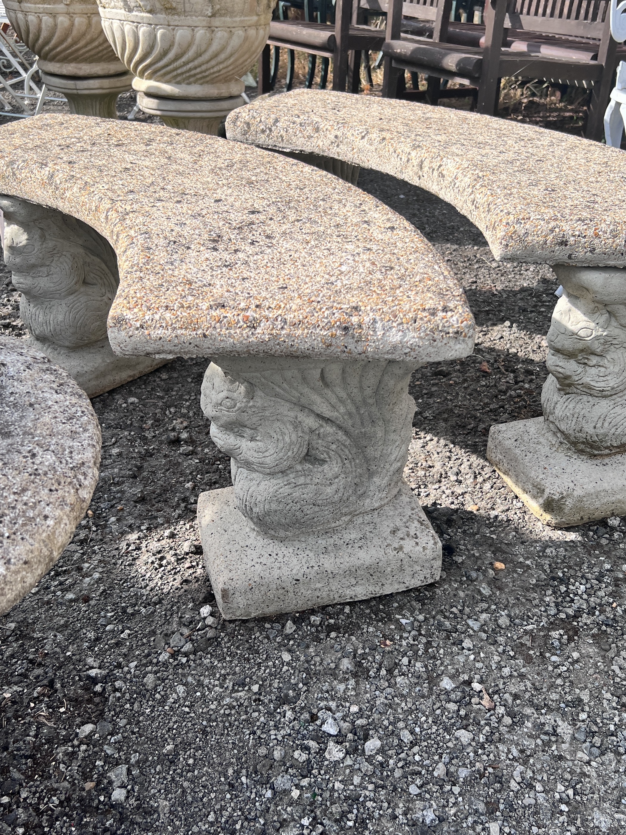 A pair of curved reconstituted stone garden benches, width 122cm, height 45cm